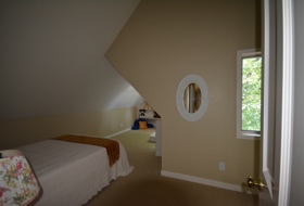 Dean Lake House 1, view of upstairs bedroom with play niche for child resident.