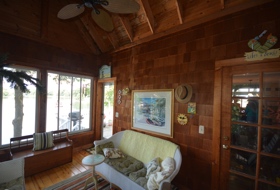 Dean Lake House 1, view of screened porch with natural cedar shingle walls and trim. A favorite room in the house for the family.