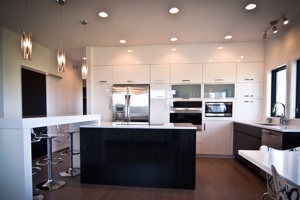 Home on Macatawa Legends Golf Course, another view of modern kitchen, clean white custom cabinetry.
